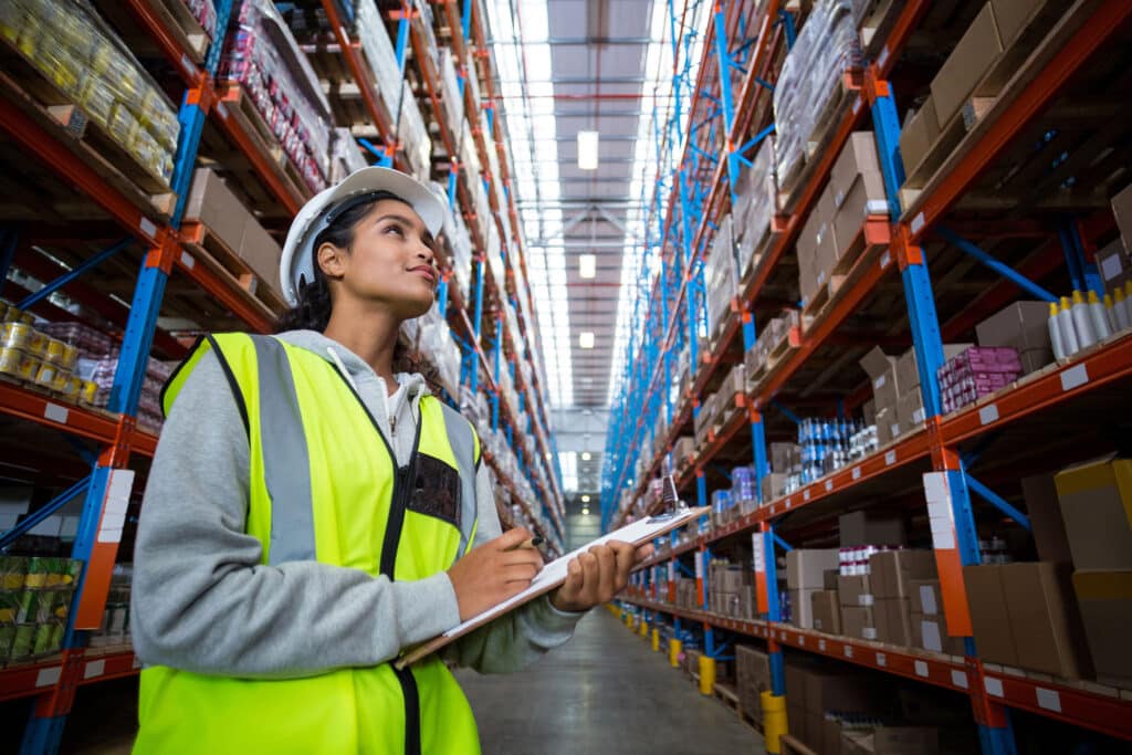 Female warehouse worker looking at packages